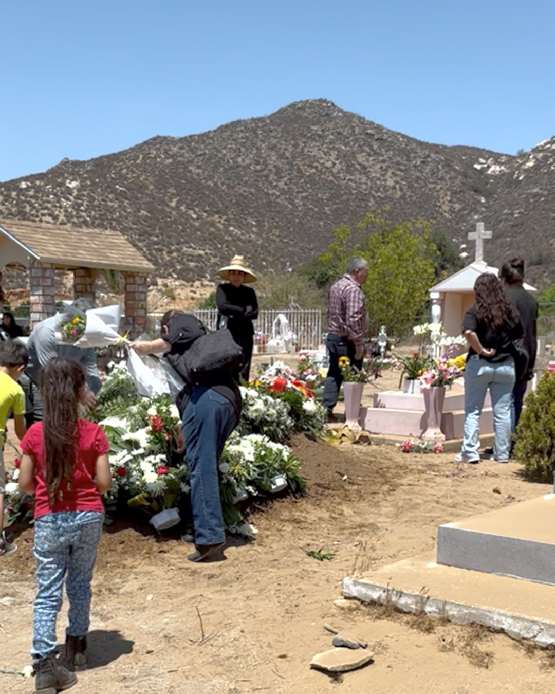 Papa Ramon was buried next to Mama Magdalena, pink and white burial to the right